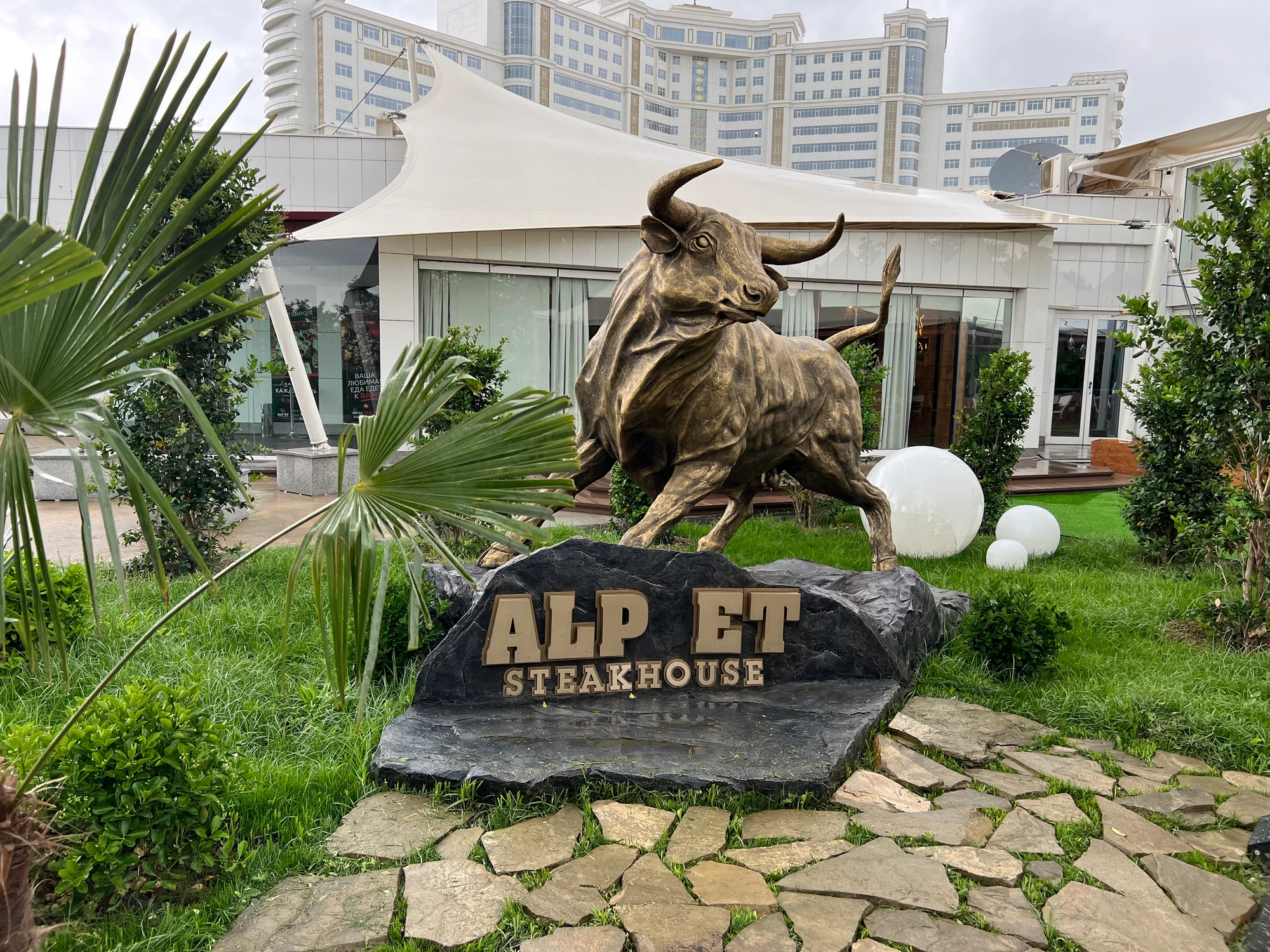 Meet the Alp Et Wall Street–style bull · Before you go, stop for a selfie with our signature bull. Tag @alpetsteakhouse and share your moment.